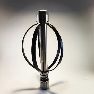 Metallic cylindrical object with curved bands against a light background.