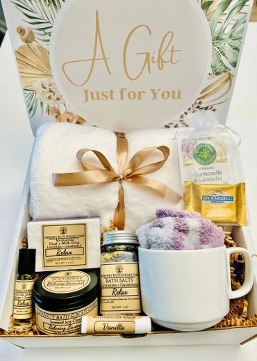 A gift box with spa essentials and a cozy towel.