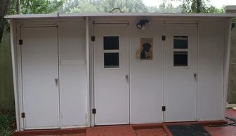 Custom dog kennel with plumbing, electricity, and extra storage by Rhino Wall Systems.