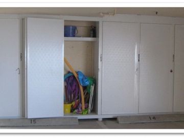 Custom outdoor storage system built on the wall to store beach items at a condo.