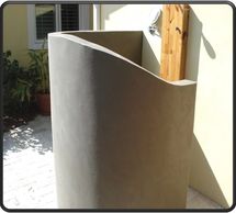 Custom outdoor enclosure shower, by a pool, to rinse off by Rhino Wall Systems.