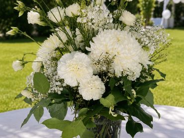 Elegant white flower bouquet in a clear vase.