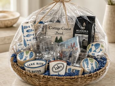 Gift basket with lake-themed items and kitchenware.