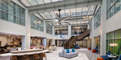 Modern open office space with high ceilings and natural light.