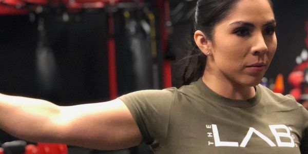 Woman working out with her arm extended.