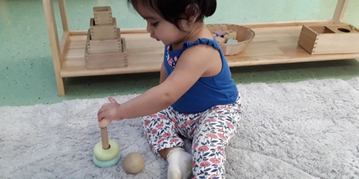A child playing with stacking toys indoors.