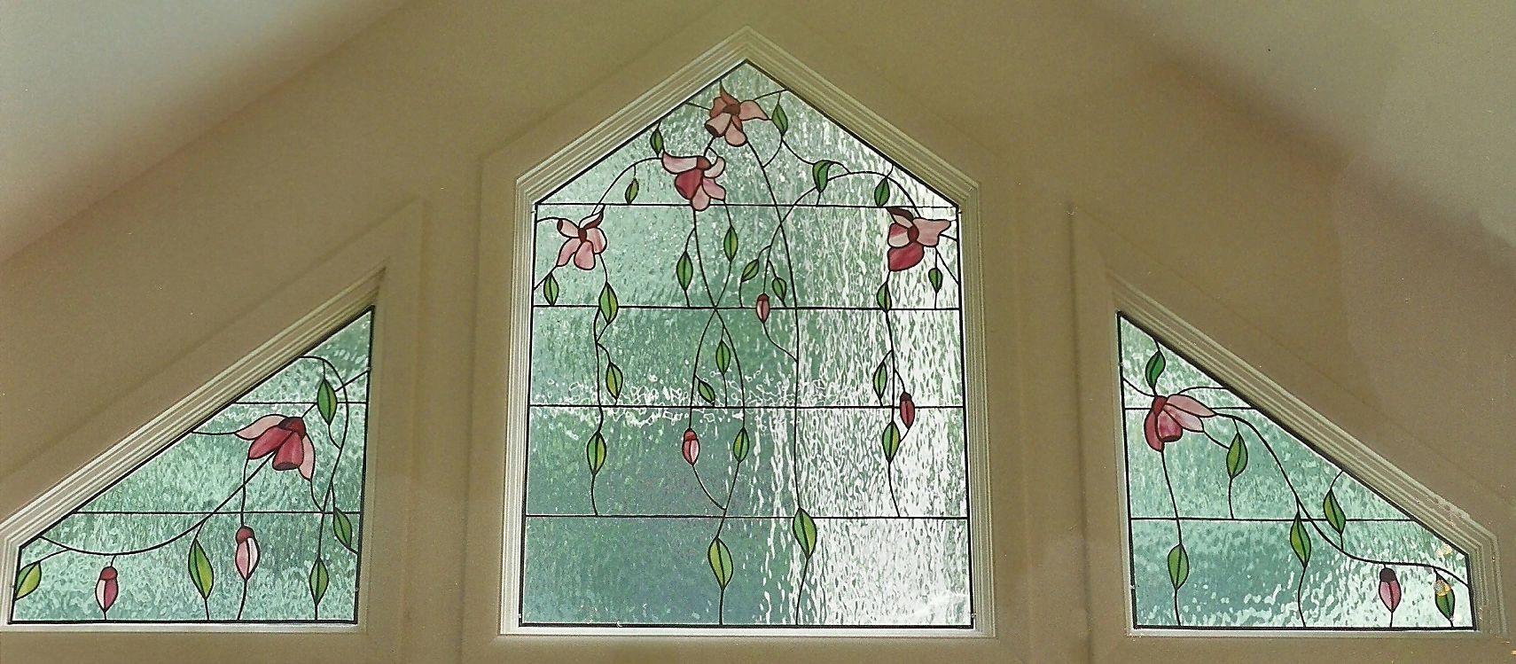 trio of stained glass windows showing flowers