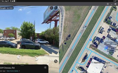 Street view of parked cars and a brick building on Dessau Road.