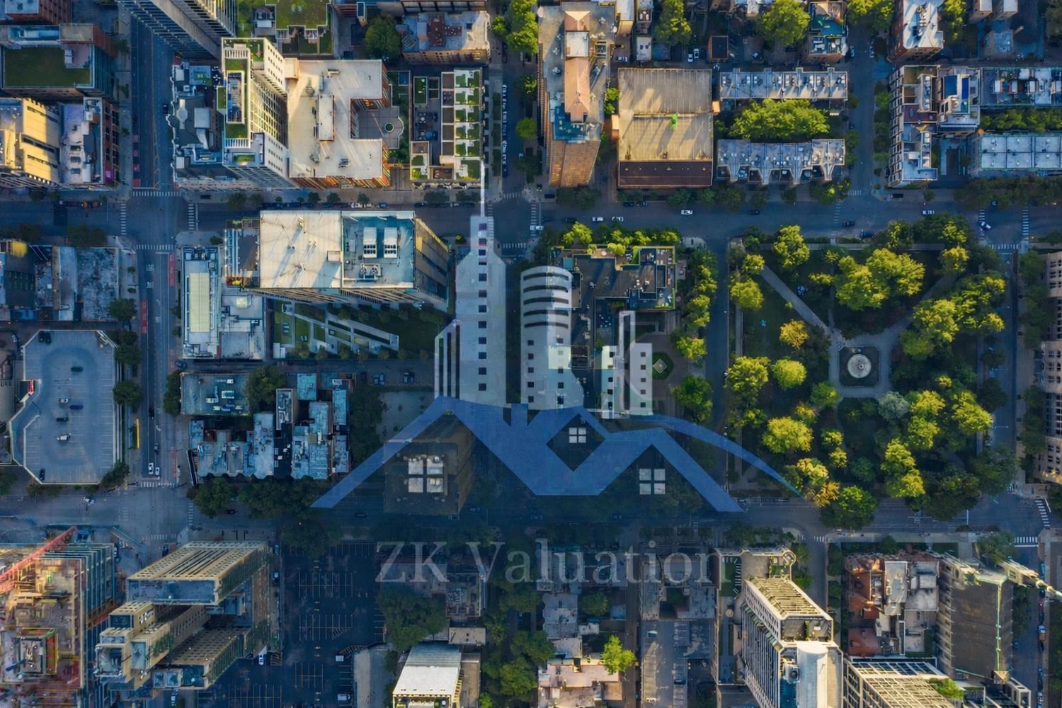 Aerial view of a city block with buildings and a green park.