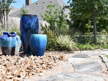 accent container fountain next to a flagstone walkway