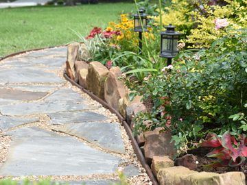 flagstone walkway and flowerbeds with landscape lights