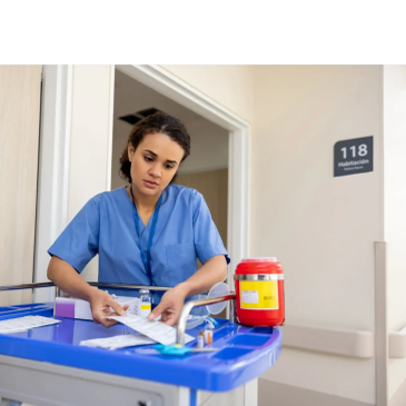 A nurse reviewing medical documents in the hallway.