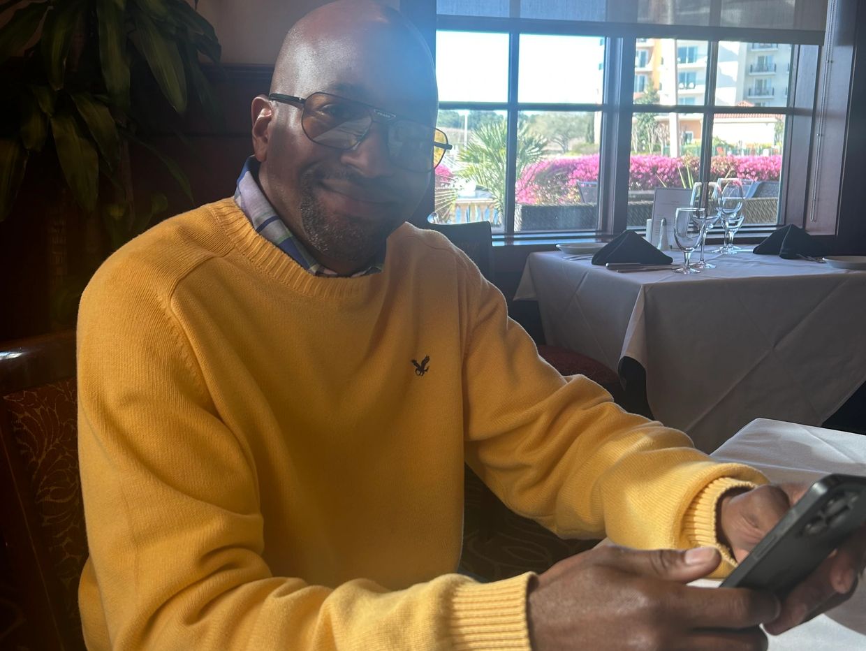 A man hold the mobile on the hand and looking ahead