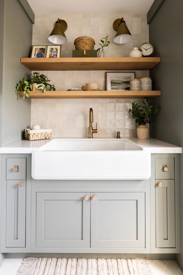 Warm and inviting laundry room with fluted sink.