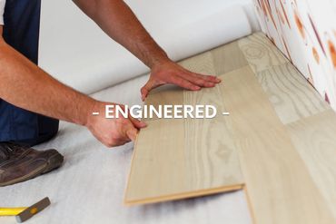 Hands installing engineered wood flooring with text overlay.