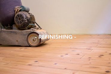 A floor sander refinishing wooden floorboards.