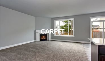 Spacious living room with gray carpet and a cozy fireplace.
