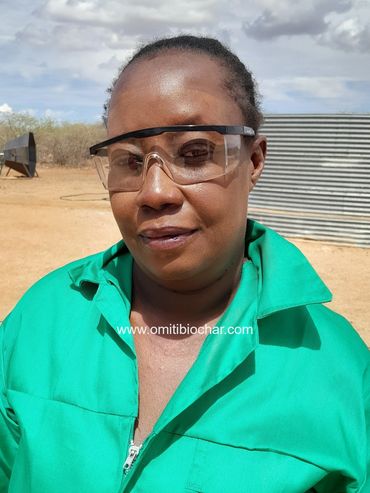 Female artisan biochar producer. © Omiti Biochar