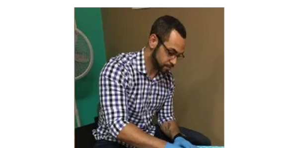 Anthony performing one of his posture corrections on an infant.