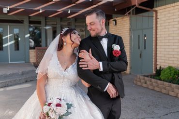 Bride and groom sharing a joyful moment on their wedding day.