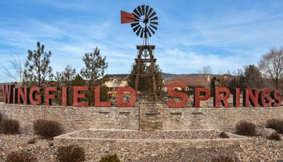 Windmill and red-lettered sign for Wingfield Springs.