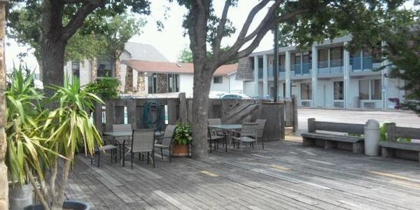 The deck at the resort with tables chairs and benches