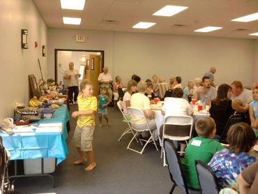 A group eating at tables in the event space at the resort