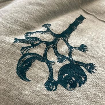 A cimaruta print on a grey shirt, for sale at Little Black Egg