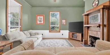 Cozy living room with green walls and wood accents.