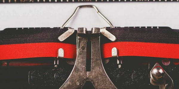 Close-up of a vintage typewriter's ink ribbon and metal parts.