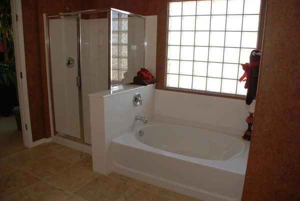 A clean shower stall and bathtub.