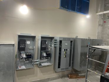 Electrical panels and circuit breakers in a utility room.