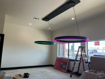 Modern room lighting with colorful circular LED fixtures.
