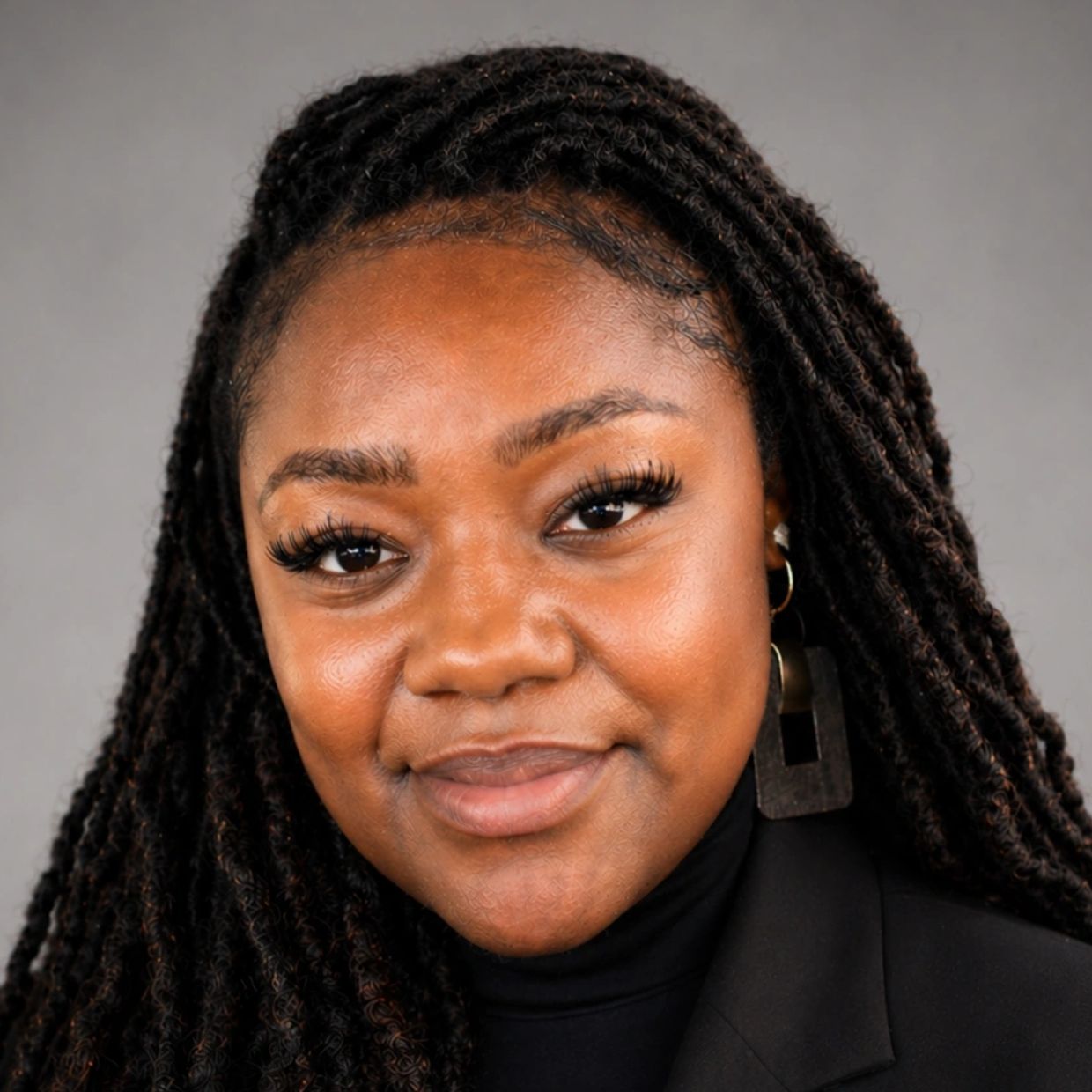 Portrait of a smiling woman with braided hair.