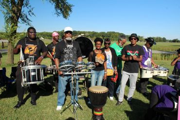 a group of people at an event playing drums