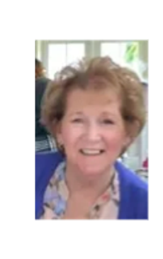 Smiling elderly woman with curly hair.