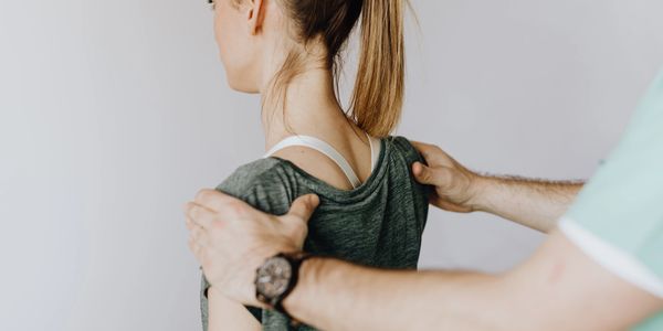 A Chiropractor examining the spine.
