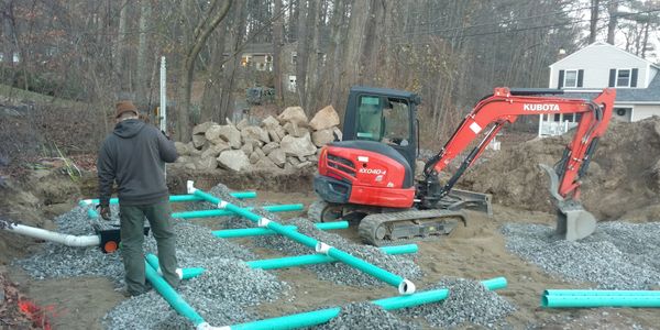 Our two sons installing a stone and pipe leachfield for a customer. This tried and true septic system is one of our preferred styles. Need a new septic system in South Portland? Give us a call!