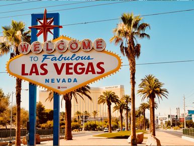 A poster of welcome to Las Vegas with along trees