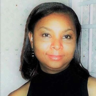 A lady wearing black dress, smiling at the camera