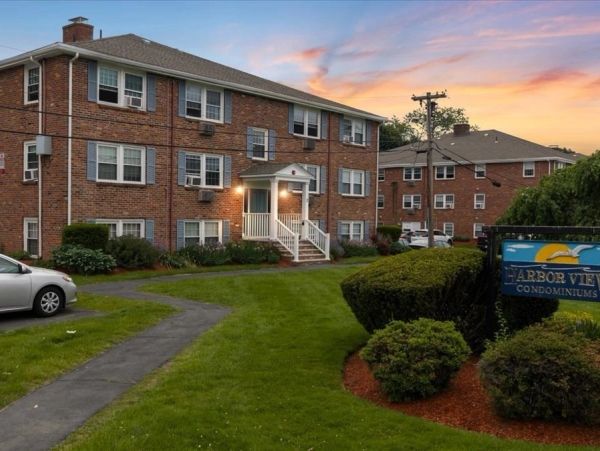 Brick condominiums at sunset with well-maintained lawns.