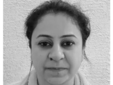 Black and white close-up portrait of a woman with a neutral expression.