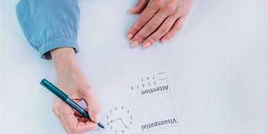 older person solving a visuospatial task on a cognitive assessment test