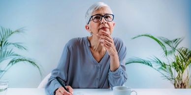 older woman thinking of an answer for a cognitive test