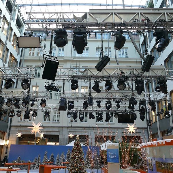 A stage for a Christmas event with lights on top