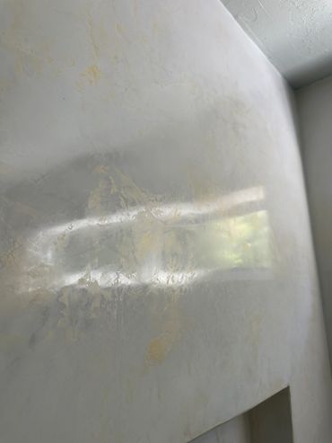 Sunlight reflection on a textured wall.