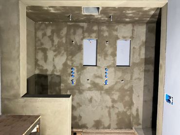 An unfinished room under construction with electrical outlets.