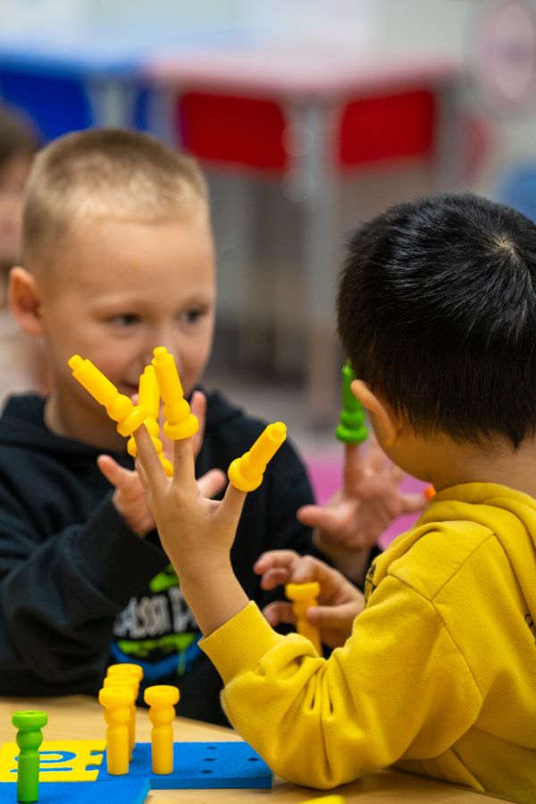 asian boy counts and uses imagination while making friends at Wee Care