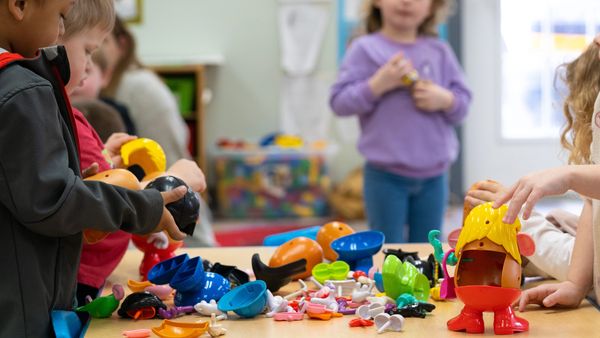 African American boy plays with friends building and using imagination for small motor skills