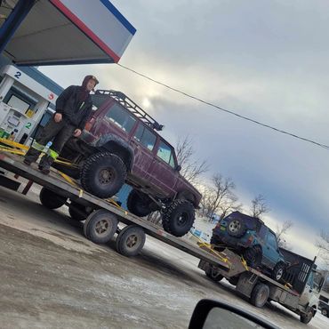 Owner hauling Jeep and Sidekick to local event